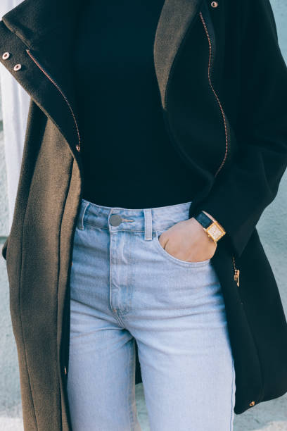 istock Slender woman in jeans and a black coat 925561144
