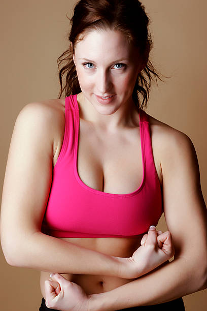 istock Red hair female displaying muscles 92556200
