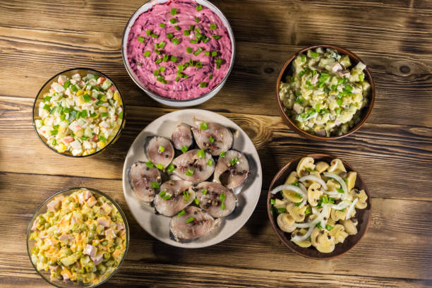 Close up of hand serving or prepare for sea food meal.Shots of the food with a human element, like a hand reaching out to the dishes or serving sea food on the plate
