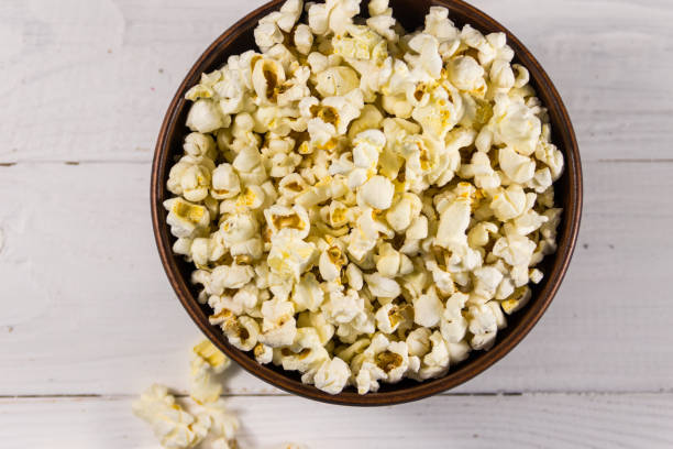 istock Bowl with popcorn on wooden table 925564950