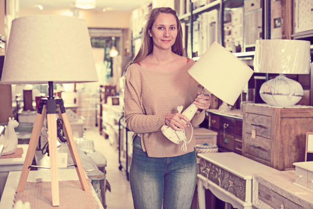 istock Woman looking for table lamp in shop 925565968