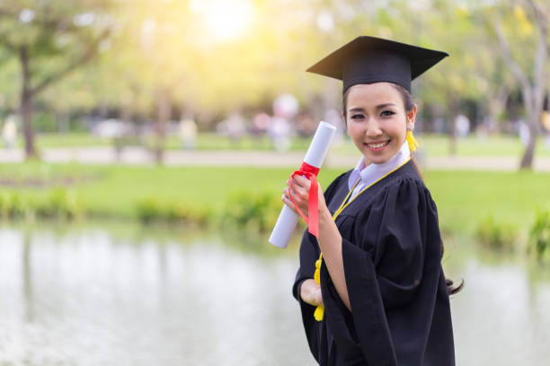 istock Graduate holding certificate in her hand and feeling so happiness in Commencement day 925578640
