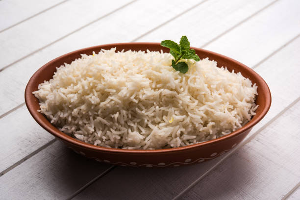 istock Cooked plain white basmati rice in terracotta bowl over plain or wooden background 925578670