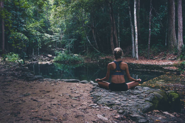 istock Woman mediting  in tropical forest 925578872