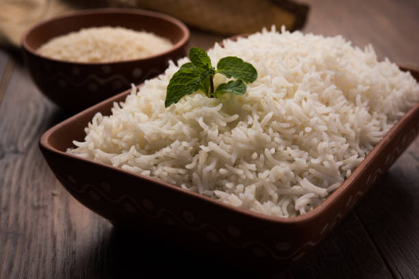 istock Cooked plain white basmati rice in terracotta bowl over plain or wooden background 925582262