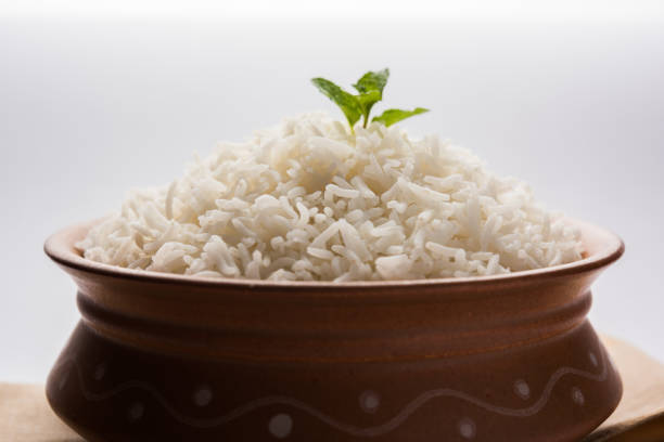 istock Cooked plain white basmati rice in terracotta bowl over plain or wooden background 925582738