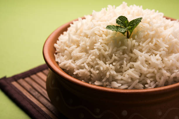 istock Cooked plain white basmati rice in terracotta bowl over plain or wooden background 925585338