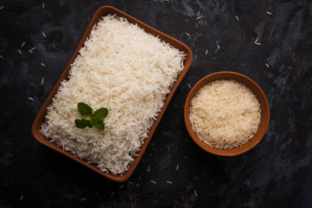 istock Cooked plain white basmati rice in terracotta bowl over plain or wooden background 925585912