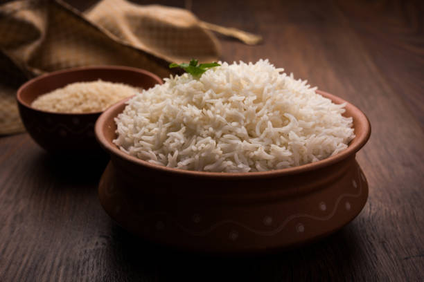 istock Cooked plain white basmati rice in terracotta bowl over plain or wooden background 925586120