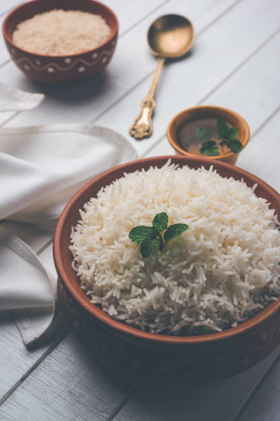istock Cooked plain white basmati rice in terracotta bowl over plain or wooden background 925587080