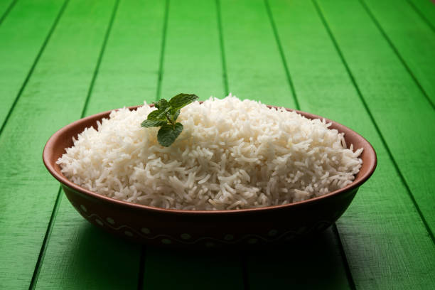 istock Cooked plain white basmati rice in terracotta bowl over plain or wooden background 925587220