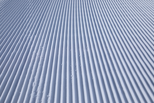 snow track lines on a ski slope left by a snowcat