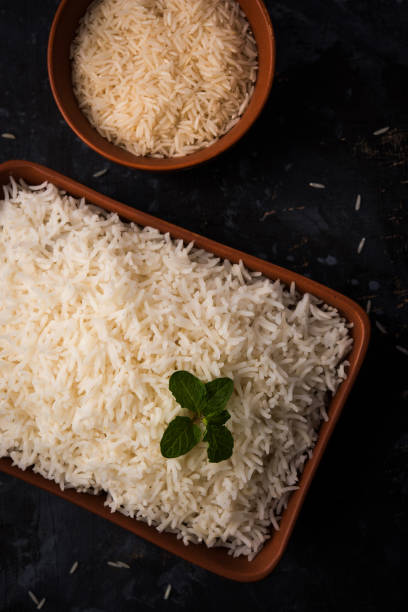 istock Cooked plain white basmati rice in terracotta bowl over plain or wooden background 925593610