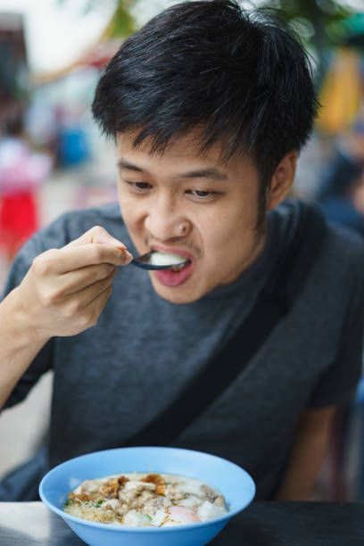 istock Asian man eating congree 925594734