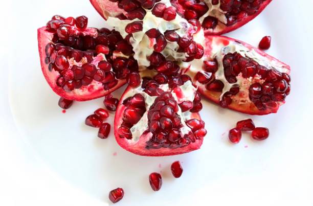 istock Fresh Juicy Pomegranate on White Plate 925597240