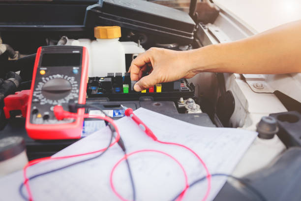 Multimeter to check the fuse in a car. Auto mechanic using digital multimeter to check the fuse in a car,check voltage level car battery. electrical fuse stock pictures, royalty-free photos & images