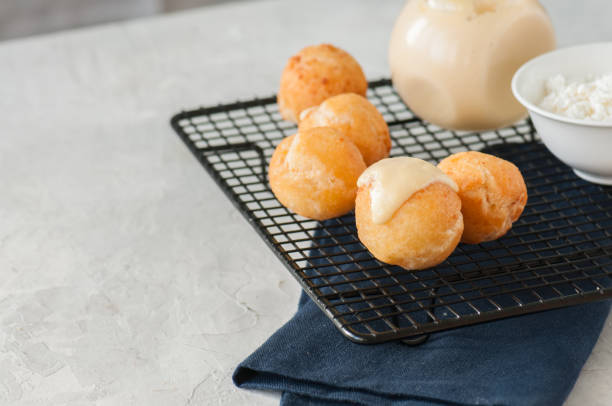istock Small cottage cheese doughnuts (castgnole) on a wire rack. 925600530