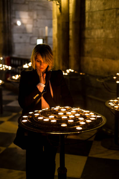 istock woman praying inside church 925604626