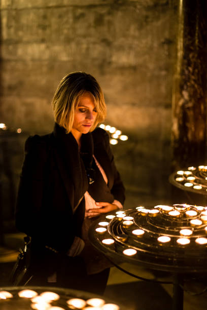istock woman praying inside church 925604640