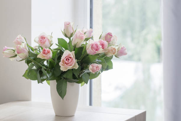 istock pink roses in vase on  background window 925605538