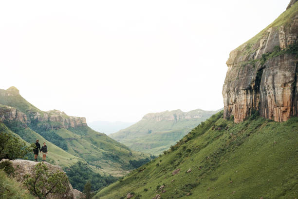 Shot of a young couple out on a hike through the mountains