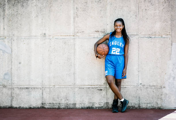 istock Confident female basketball player against wall 925612086