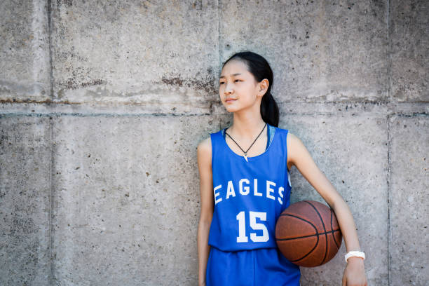 istock Confident basketball player standing with ball 925612124