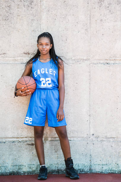 istock Full length female player with ball against wall 925612204