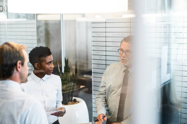 istock Businessman discussing with colleagues in office 925612392