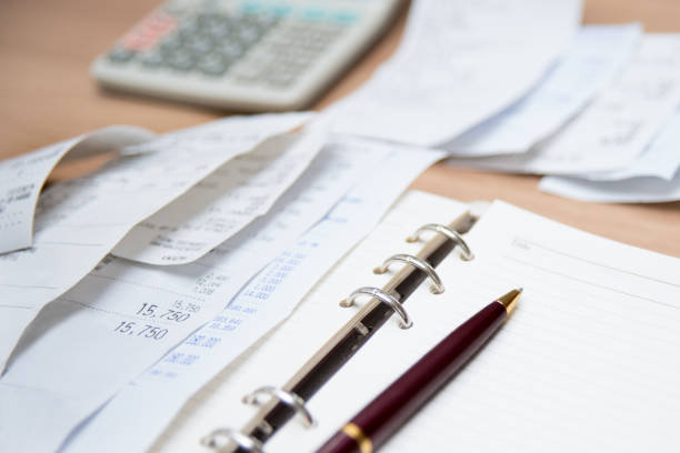 Checking receipt. Finance concept with receipts, calculators, and notes. Defocused.