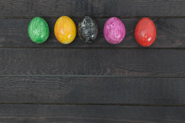 istock Easter eggs in pastel colors on old rustic wooden background with empty place for text. Top view. Copy space. 925619634
