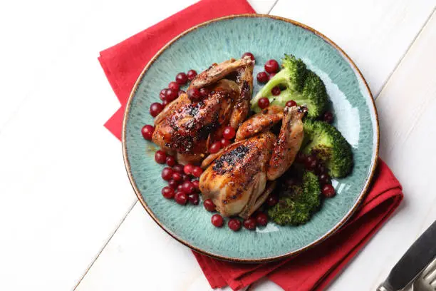 Photo of Roasted quails with broccoli and cranberries