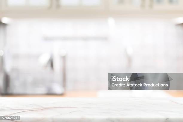 Marble Stone Countertop On Blur Kitchen Interior Background Stock Photo - Download Image Now