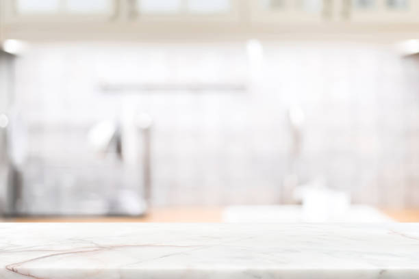 marble stone countertop on blur kitchen interior background - balcão imagens e fotografias de stock