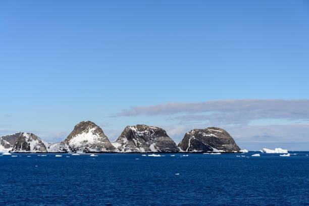 istock Rocks with snow in sea 925626458