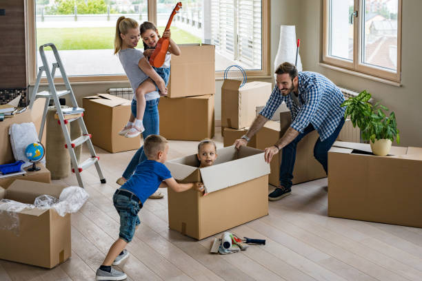 istock Young happy parents playing with their children while relocating into new home. 925627234