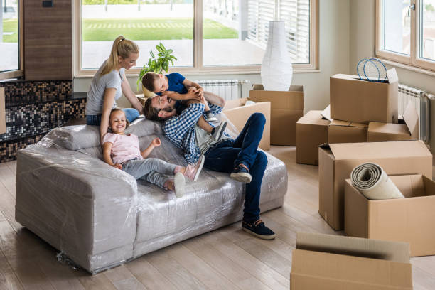istock Happy family having fun while taking a break from relocating into new apartment. 925628346