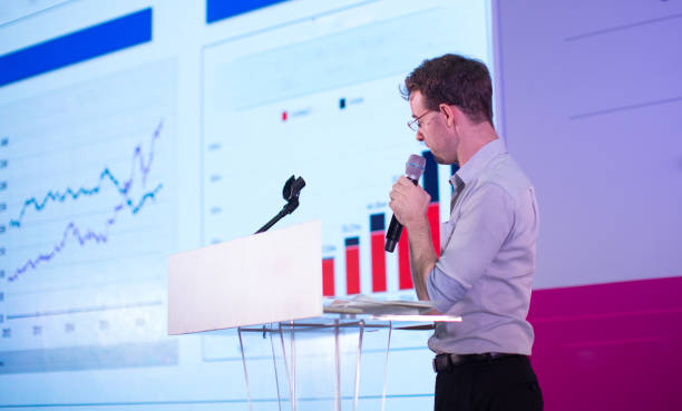 istock Business Presentation. Presenter Showing Charts and Graphs. 925628736