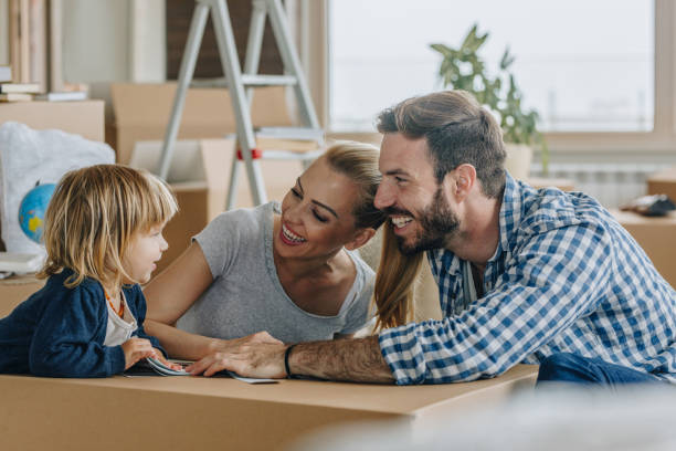 istock Happy parents talking to their small son while moving into new apartment. 925631304