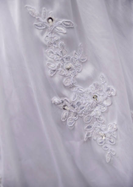 detail of decorating white wedding dresses for the bride stock photo