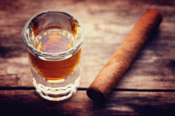 istock Whiskey or bourbon in a shot glass and cigar 925633004