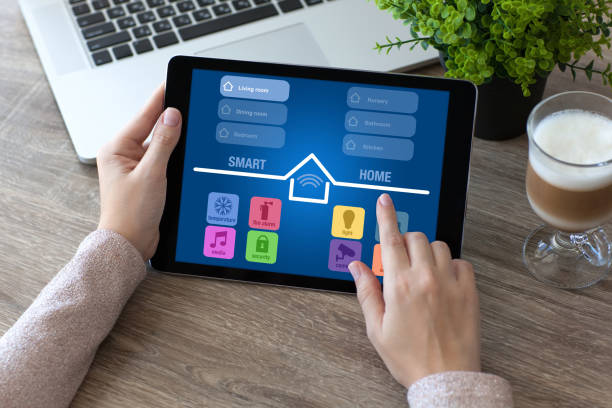istock woman hands holding tablet computer with app smart home room 925633352