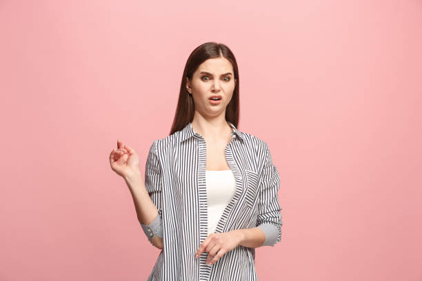 istock Young woman with disgusted expression repulsing something, isolated on the pink 925636218