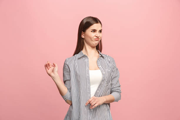 istock Young woman with disgusted expression repulsing something, isolated on the pink 925636276