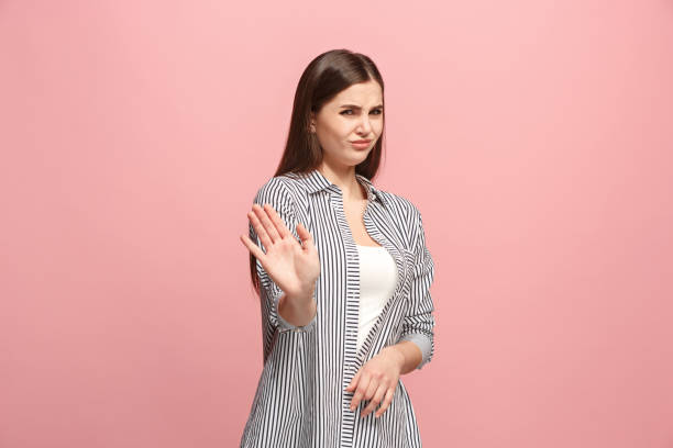 istock Let me think. Doubtful pensive woman with thoughtful expression making choice against pink background 925636358