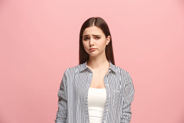 istock Beautiful woman looking suprised and bewildered isolated on pink 925639006