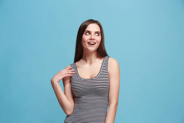 istock Let me think. Doubtful pensive woman with thoughtful expression making choice against blue background 925639950