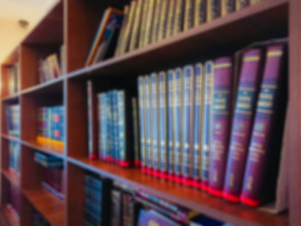 istock Defocused image. Multi-colored books on the bookshelf in the library. The bokeh effect 925640142