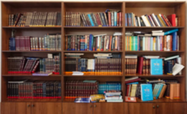 istock Defocused image. Multi-colored books on the bookshelf in the library. The bokeh effect 925640176