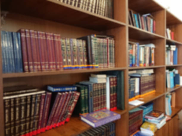 istock Defocused image. Multi-colored books on the bookshelf in the library. The bokeh effect 925640206